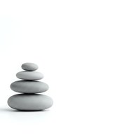 Zen balanced stone stack on white background for meditation, wellness and spa concepts with copy space.