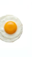 Fried egg with golden yolk isolated on white background for breakfast menu design and culinary projects.