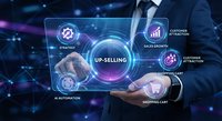 Professional businessman touching futuristic holographic interface displaying up-selling strategy with digital marketing icons and data analytics elements.