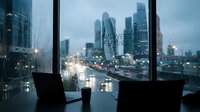 Modern office workspace with laptop and coffee cup overlooking illuminated city skyline at dusk through large windows for business and productivity concepts.