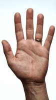 Open male hand with wedding ring showing palm and fingers against white background isolated for design and communication concepts.