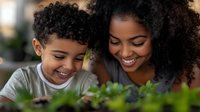 Young African American mother and son share joyful moment while gardening together, both smiling with natural curly hair, representing family bonding and outdoor activities.