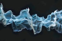 Ethereal blue smoke waves creating abstract flowing patterns against dark background, dynamic movement captured in soft translucent shapes for artistic designs.