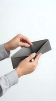 Businessman hands holding empty gray leather wallet showing financial crisis or bankruptcy concept on white background.