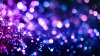 Magical purple and blue bokeh lights creating dreamy abstract background with glowing defocused circles. Festive blurred pattern for holiday designs.