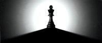 Queen chess piece silhouetted against bright backlit glow, symbolizing leadership, strategy, and power for business and game concepts.