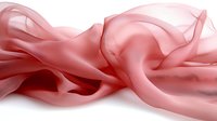 Flowing pink silk fabric with gentle folds and waves creates soft ethereal texture against white background, suitable for luxury fashion and beauty designs.