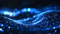 Glowing blue wave of light particles and bokeh effects on dark background creates magical atmosphere for festive designs and presentations.