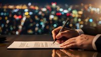 Professional businessman signing important contract document with pen at night office desk with blurred city lights background for corporate deals.