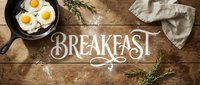 Fried eggs in cast iron skillet on rustic wooden table with flour lettering Breakfast, rosemary herbs and linen napkin, top view.