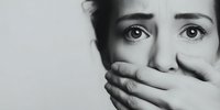 Emotional black and white portrait of woman with hand covering mouth, expressing fear, shock, or silence in dramatic lighting for conceptual use.