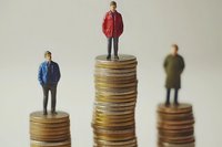 Male figures standing on stacks of coins showing financial inequality, wage gap, and income differences in business and economy. Social class concept.
