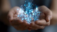 Glowing blue magical particles and light effects floating above cupped hands against dark background, creating mystical energy visualization for spiritual concepts.