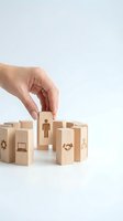 Hand selecting wooden block with person icon from business concept blocks on white background for HR and recruitment strategies.