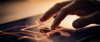 Hand touching digital tablet screen with glowing light effects and futuristic interface elements for technology and innovation concepts.