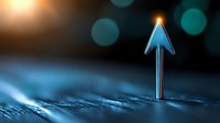 Glowing upward arrow on digital surface with bokeh lights background creates futuristic business growth concept for financial presentations and reports.