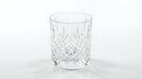 Crystal cut glass tumbler with diamond pattern isolated on white background for elegant drinkware and luxury dining concepts.