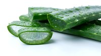 Fresh green cucumber slices and whole cucumbers with water droplets on white background, suitable for food, nutrition, cooking, and healthy eating content.