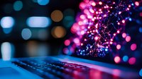 Glowing keyboard with vibrant pink and blue bokeh lights creating magical atmosphere. Modern technology concept with defocused illumination and sparkles.