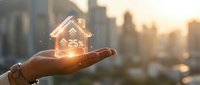 Hand holding glowing house model with 25% discount symbol at sunset, real estate investment and property sales concept for marketing materials.