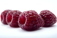 Fresh ripe raspberries in macro view on white background showing detailed texture and natural red color, suitable for food packaging and healthy lifestyle promotion.