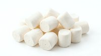 Pile of white marshmallows isolated on white background, ready for design use in food, confectionery, and dessert projects.