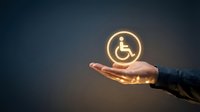 Businessman hand holding glowing wheelchair accessibility icon symbol for disability support, inclusive care, and social responsibility services.