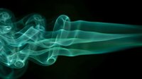Ethereal turquoise smoke swirls gracefully against dark background creating mystical flowing patterns for creative design projects and artistic compositions.
