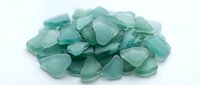 Polished green aventurine tumbled stones heap isolated on white background, used for crystal healing, meditation, wellness practices, and mineral collecting.