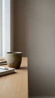 Ceramic cup on wooden desk with notebook and pen near window, minimalist workspace setup for office, creative, and lifestyle design projects.