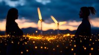 Silhouettes of two women at sunset with wind turbines and magical glowing particles creating dreamy atmosphere against dramatic sky and mountain landscape.