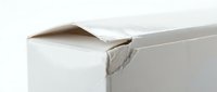 Damaged white cardboard box with torn corner and bent edges showing wear and shipping damage on clean background.