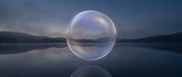 Translucent sphere floating above calm lake water at dusk with mountains in background, creating surreal reflection and ethereal atmosphere for conceptual and fantasy projects.