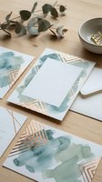 Elegant watercolor wedding invitation suite with eucalyptus leaves and gold geometric accents on wooden surface for luxury stationery design.