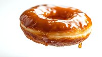 Freshly glazed donut with dripping caramel coating on white background, appetizing pastry dessert with glossy topping and golden brown dough.