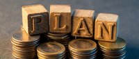 Wooden blocks spelling PLAN surrounded by stacks of coins representing financial planning and investment strategy for business growth and wealth management.