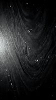 Abstract black textured surface with flowing curved lines and scattered white particles creating dramatic contrast for modern design backgrounds.