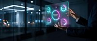 Businessman holding transparent digital interface with glowing neon circles and data visualization symbols in modern office environment for technology and innovation concepts.