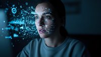Young Caucasian man with digital holographic interface projections around face showing futuristic technology concepts for AI and machine learning applications.