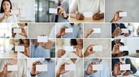 Close-up of diverse hands holding blank white business cards in professional office settings, suitable for corporate branding, networking, and business identity marketing campaigns.