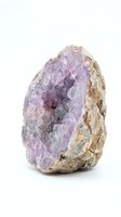 Amethyst geode with purple crystalline interior and tan matrix exterior, isolated on white background for mineral collection, geology education, and wellness design use.