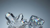Sparkling cut diamonds and precious gemstones with brilliant rainbow reflections on gradient background for luxury jewelry design and investment concepts.