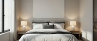 Cozy bedroom interior with white bedding, dark gray pillows, wooden nightstands, table lamps, and blank wall art above bed for home decor and interior design projects.