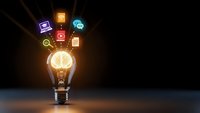 Glowing light bulb with colorful digital icons floating above representing innovation, creativity and business ideas on dark background.