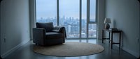 Modern luxury apartment interior with dark leather armchair, round beige rug, side table with lamp, and floor-to-ceiling windows overlooking city skyline for contemporary home design.
