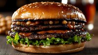 Stacked beef patties with melted cheese, crispy lettuce, and sesame seed bun. Gourmet burger for food photography, restaurant menus, culinary blogs.