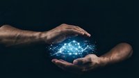 Two hands with medium skin tone cradling a glowing cloud network symbol against dark background, representing cloud computing, data protection, technology transfer, and digital innovation for business and IT solutions.