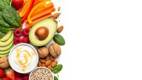 Fresh healthy foods including avocado, nuts, berries and vegetables arranged on white background for nutritious diet and wellness lifestyle.