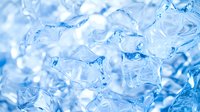 Frozen ice cubes with blue tint in macro photography showing crystal structure and transparency. Cold refreshing background with melting frost and water drops.