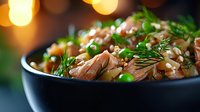 Savory beef stew with tender meat, green peas and fresh herbs in dark bowl. Warm comfort food with bokeh lights background for cozy dining atmosphere.